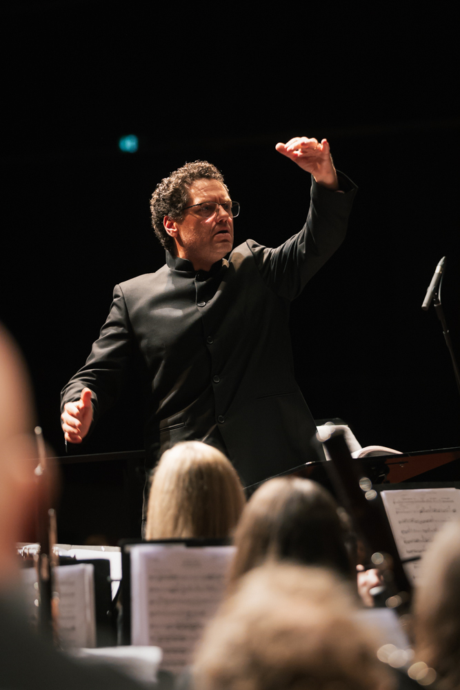 Dirigent der Stadtkapelle Wernau leitet das Orchester während einer Aufführung, um Musiker und Musikliebhaber im Raum Esslingen und Stuttgart anzusprechen.